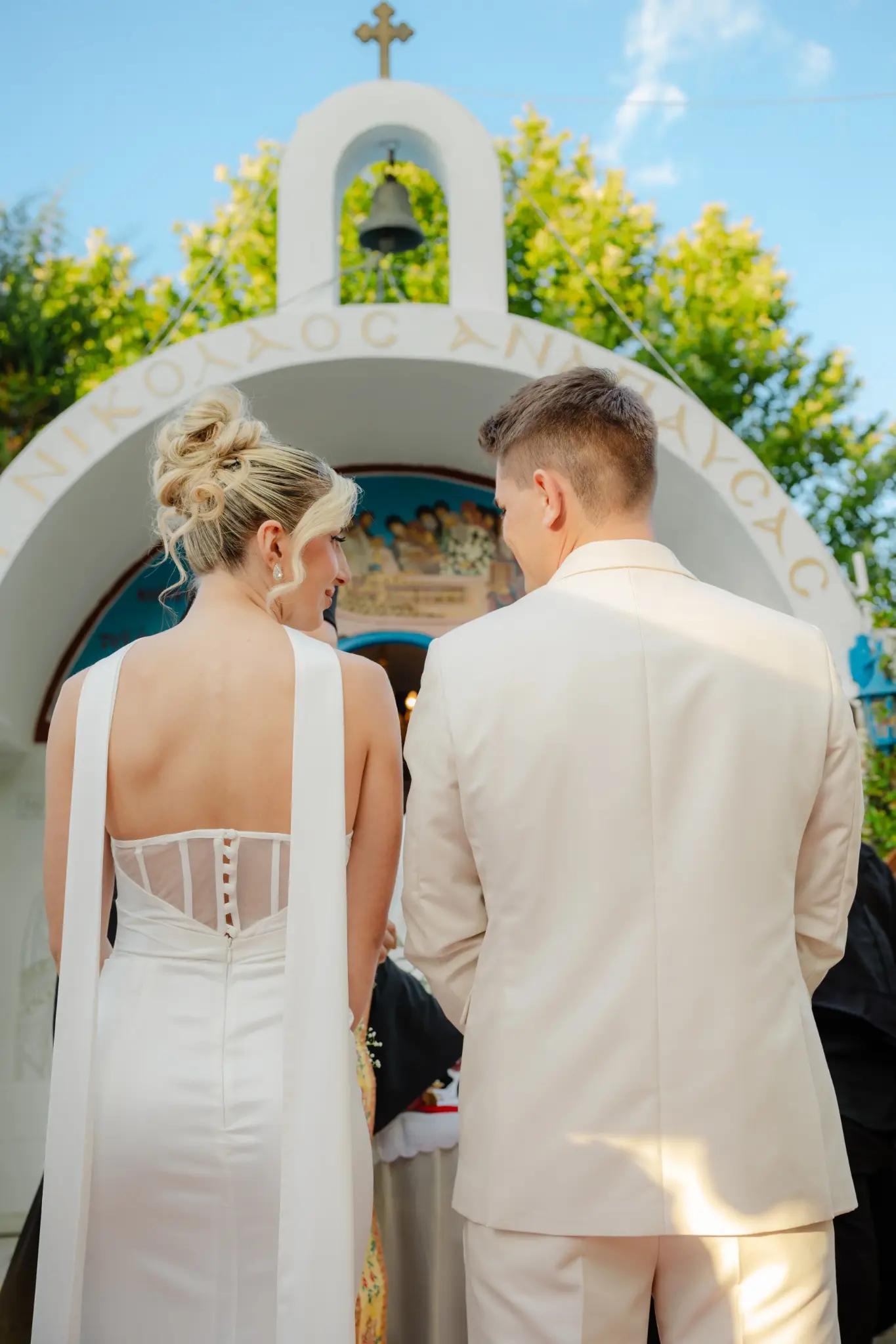 Newlyweds at the entrance of a Greek chapel