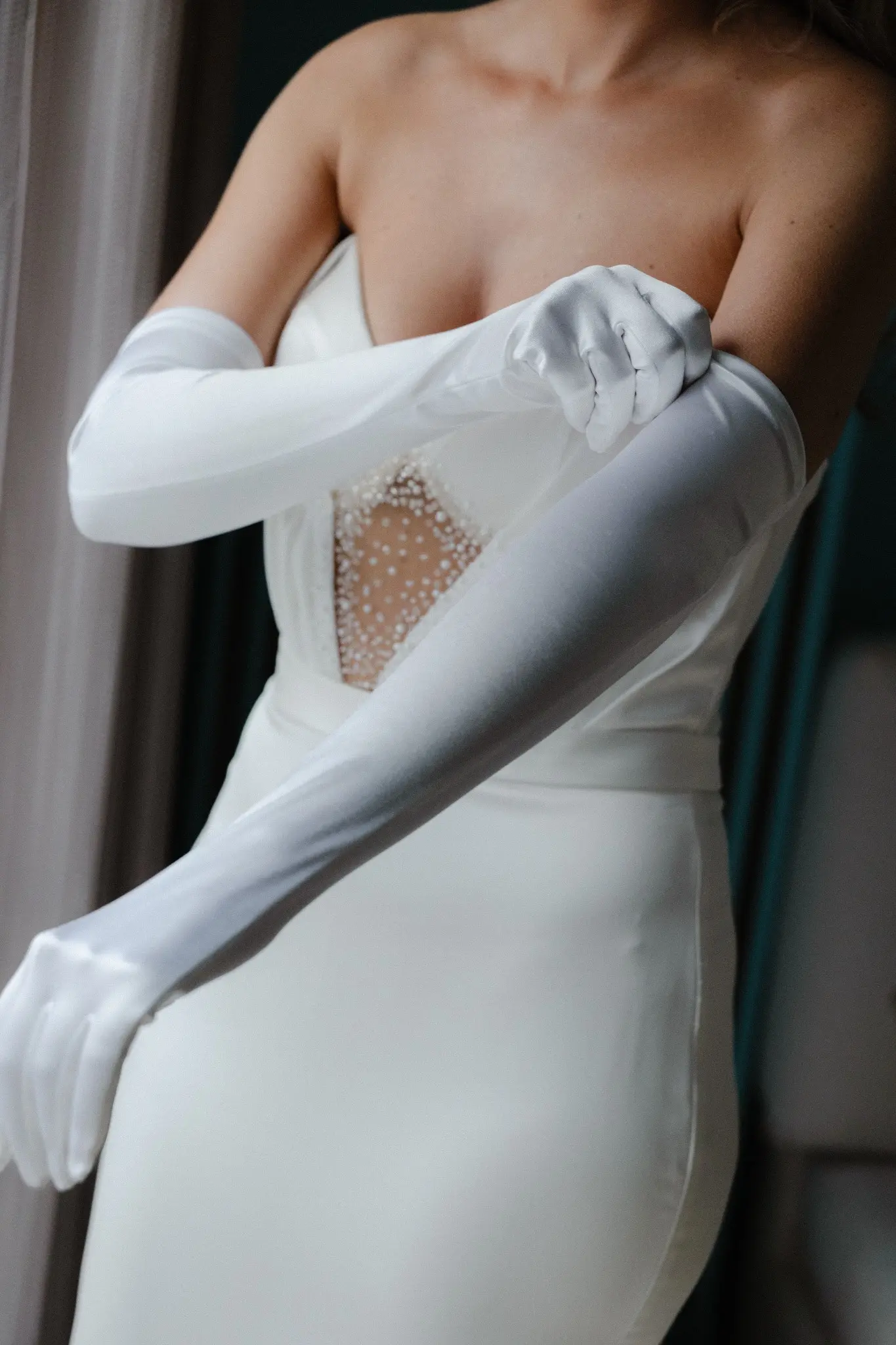 Bride fastening an elegant white glove